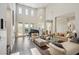 Bright living room with a piano, fireplace, and access to the outdoor area through sliding glass doors at 2690 Grassy Spring Pl, Las Vegas, NV 89135