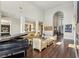Open-concept living room featuring high ceilings, a piano, and seamless flow to other living spaces at 2690 Grassy Spring Pl, Las Vegas, NV 89135