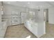 Bright kitchen featuring white cabinets, an island with cabinets, and stainless steel appliances at 2849 Blythswood Sq, Henderson, NV 89044