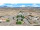 Stunning aerial view of a sprawling desert property featuring a pool, lush landscaping, and mountain views at 2901 S Dandelion St, Pahrump, NV 89048