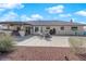 View of the home's backyard, which includes a large patio area perfect for entertaining and a desert landscaped yard at 2901 S Dandelion St, Pahrump, NV 89048