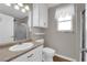 Bathroom with vanity, white cabinets, and window for natural lighting at 2901 S Dandelion St, Pahrump, NV 89048