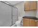 Neutral bathroom featuring a toilet, shower with sliding door, and a vanity cabinet at 2901 S Dandelion St, Pahrump, NV 89048