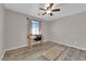 Bedroom with wood-look flooring, neutral walls, and a ceiling fan at 2901 S Dandelion St, Pahrump, NV 89048