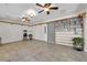 Spacious bonus room featuring tile floors, custom shelving, ceiling fans, and entertainment options at 2901 S Dandelion St, Pahrump, NV 89048