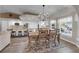 Open floor plan showcasing dining room with rustic table and chairs with kitchen in the background at 2901 S Dandelion St, Pahrump, NV 89048
