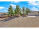 Long driveway to garage is surrounded by natural desert landscaping at 2901 S Dandelion St, Pahrump, NV 89048