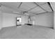Spacious garage featuring laundry area, white cabinets, and ample storage at 2901 S Dandelion St, Pahrump, NV 89048