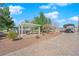 Expansive grounds feature a covered patio with seating, mature trees, and ample parking at 2901 S Dandelion St, Pahrump, NV 89048