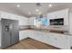 Spacious kitchen with white cabinets, stainless steel appliances, and wood-look flooring at 2901 S Dandelion St, Pahrump, NV 89048