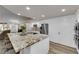 Elegant kitchen island featuring a granite countertop, seating, and a view of the living area at 2901 S Dandelion St, Pahrump, NV 89048