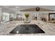 Kitchen island with cooktop and granite countertop, connecting the kitchen to the living area at 2901 S Dandelion St, Pahrump, NV 89048