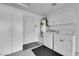 Garage featuring laundry area, white cabinets, utility sink and door to the outside at 2901 S Dandelion St, Pahrump, NV 89048