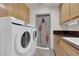 A laundry room with a washer, dryer, and lots of cabinet space at 2901 S Dandelion St, Pahrump, NV 89048