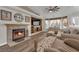 Comfortable living room with a fireplace, tv, mantel and neutral decor, perfect for relaxation at 2901 S Dandelion St, Pahrump, NV 89048