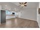 Living room view showcasing hardwood floors, ceiling fan, and white kitchen cabinets at 2901 S Dandelion St, Pahrump, NV 89048