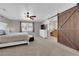 A spacious main bedroom with a barn door leading to the bathroom at 2901 S Dandelion St, Pahrump, NV 89048