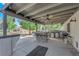 An extensive outdoor kitchen and bar area featuring stainless steel appliances and multiple ceiling fans for added comfort at 2901 S Dandelion St, Pahrump, NV 89048