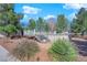 Inviting above-ground pool with decking surrounded by lush landscaping and mature trees at 2901 S Dandelion St, Pahrump, NV 89048