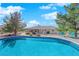 A built-in pool surrounded by deck chairs and a gray patio at 2901 S Dandelion St, Pahrump, NV 89048
