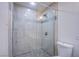 Bathroom with stylish shower featuring glass doors, mosaic trim, and pebble floor at 3060 Tarpon Dr # 104, Las Vegas, NV 89120