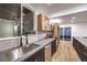 Updated kitchen featuring stainless steel appliances, subway tile, and a view to outdoor patio at 3240 Medicine Man Way, Las Vegas, NV 89169