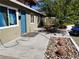 View of a one-story home highlighting the walkway, desert landscaping, and proximity to a neighboring structure at 333 N 13Th St, Las Vegas, NV 89101
