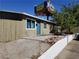 Simple one-story house featuring a light-colored exterior, small front yard, and an adjacent fence at 333 N 13Th St, Las Vegas, NV 89101