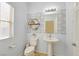 Half-bath with decorative mirror and pedestal sink at 376 Shanon Springs St, Henderson, NV 89014