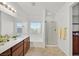 Bright bathroom featuring double sinks, a bathtub, and a glass door shower at 376 Shanon Springs St, Henderson, NV 89014