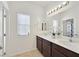 Bathroom featuring double sinks and vanity, large mirror and a tub/shower at 376 Shanon Springs St, Henderson, NV 89014