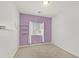 Bedroom with a large window, purple accent wall, and hanging shelves at 376 Shanon Springs St, Henderson, NV 89014