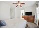 Bright bedroom featuring a ceiling fan, and a large dresser with a television on top at 376 Shanon Springs St, Henderson, NV 89014