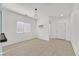 Bright, neutrally decorated dining room with tile flooring and modern light fixture at 376 Shanon Springs St, Henderson, NV 89014
