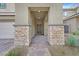 Inviting front porch with stone accents and a paved walkway leading to the front door at 376 Shanon Springs St, Henderson, NV 89014