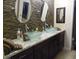 Elegant bathroom featuring dual vessel sinks and a decorative tiled backsplash at 3781 Desert Marina Dr # 101, Laughlin, NV 89029
