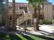 View of a two-story condo building with desert landscaping, including palm trees and cacti at 3781 Desert Marina Dr # 101, Laughlin, NV 89029