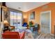 Cozy living room with bright-colored walls, stylish chairs, and access to the backyard at 3898 Blake Canyon Dr, North Las Vegas, NV 89032