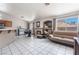 Bright living room with a fireplace, tile floors, and large windows at 4142 Forestville St, North Las Vegas, NV 89032