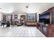 Spacious living room with a fireplace, tile flooring, and modern furnishings at 4142 Forestville St, North Las Vegas, NV 89032