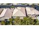 Nevada home with a tile roof, lush backyard landscaping, and mature shade trees at 4712 Stavanger Ln, Las Vegas, NV 89147