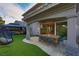 An outdoor living space featuring a dining table, hanging chair, and outdoor hot tub at 4712 Stavanger Ln, Las Vegas, NV 89147