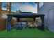 Backyard with a hot tub, fire pit and covered seating at 4712 Stavanger Ln, Las Vegas, NV 89147