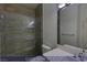 A guest bathroom that features an elegant glass-enclosed shower and modern vanity at 4712 Stavanger Ln, Las Vegas, NV 89147
