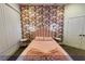 A guest bedroom with decorative wallpaper, sconces, and stylish headboard at 4712 Stavanger Ln, Las Vegas, NV 89147