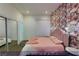 Bedroom featuring a mirrored closet and an accent wall covered in a collage of photos at 4712 Stavanger Ln, Las Vegas, NV 89147
