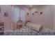 Bedroom featuring pink walls, decorative hearts, and a cozy single bed with matching linens at 4712 Stavanger Ln, Las Vegas, NV 89147