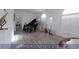 Spacious dining room featuring wood floors, grand piano, and lots of natural light from large windows at 4712 Stavanger Ln, Las Vegas, NV 89147