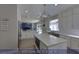 Bright kitchen featuring white cabinets, stainless steel appliances, a large island, and modern lighting at 4712 Stavanger Ln, Las Vegas, NV 89147