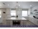 Well-lit kitchen featuring a stylish island, white cabinets and modern appliances at 4712 Stavanger Ln, Las Vegas, NV 89147